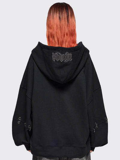 Black zip up hoodie jacket with white grunge print patches and eyelets with O-ring and piercing details.