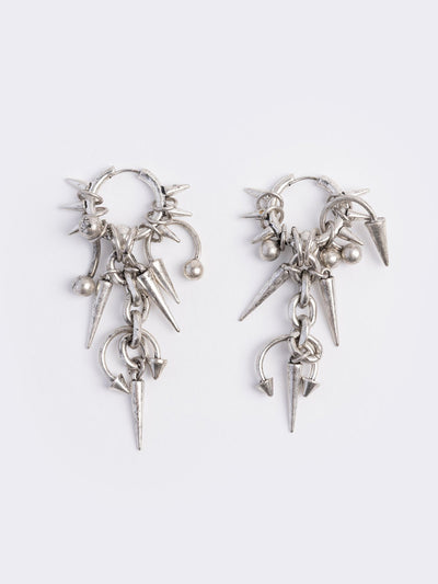Silver chunky hoop earring with spike and piercing pendants.