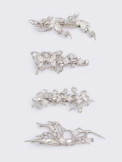 Set of 4 hair clips with butterflies and sigilism design and white stone details.