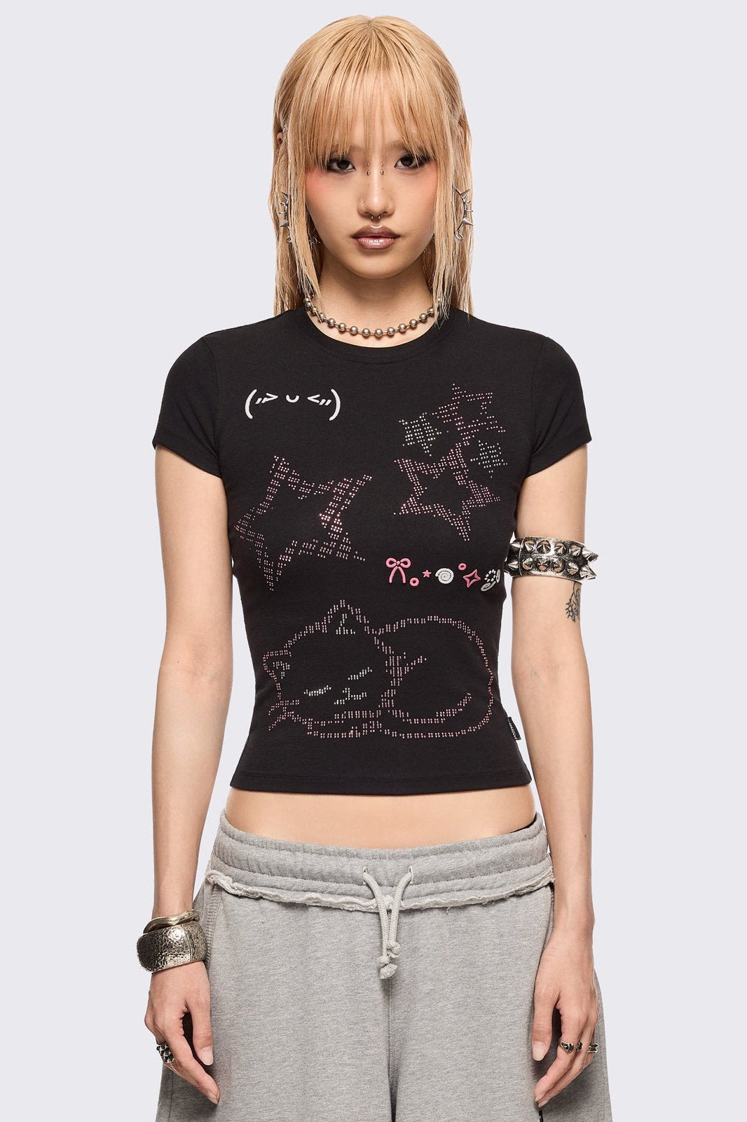 Black baby tee with kitty and stars graphic with stud and embroidery details.