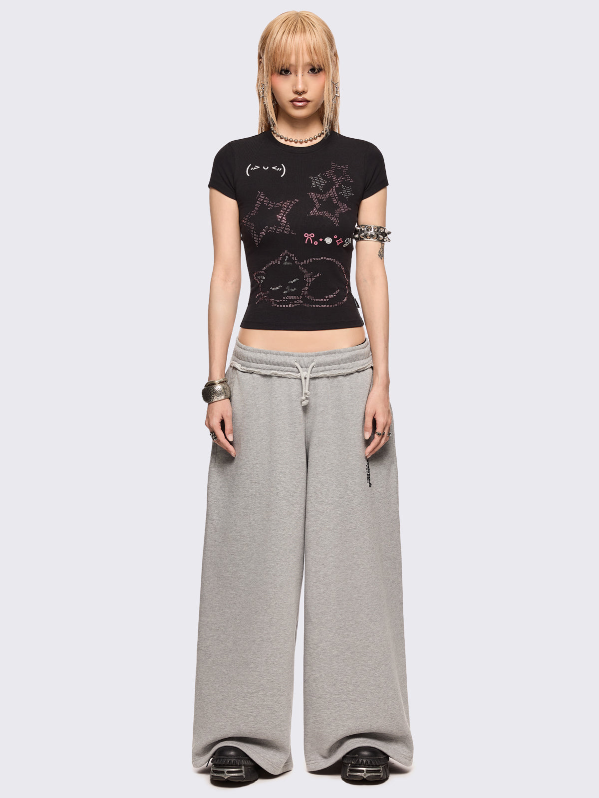 Black baby tee with kitty and stars graphic with stud and embroidery details.
