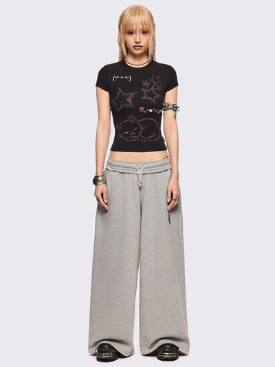 Black baby tee with kitty and stars graphic with stud and embroidery details.