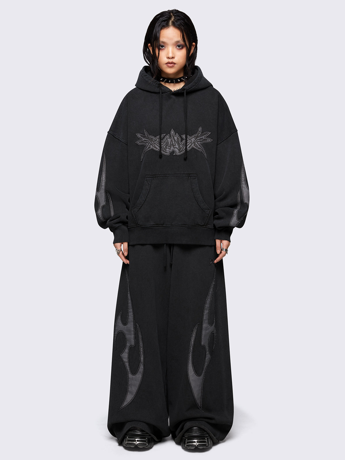 Black washed hoodie with grey sigilism embroidered patches, drawstring hood, and kangaroo pockets