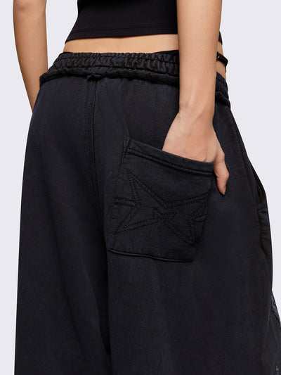 Black washed wide leg sweatpants with grey sigilism patches.