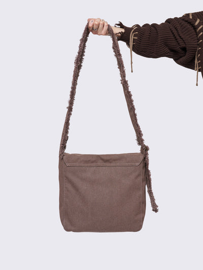 Canvas messenger bag in washed brown with grunge graphic print with gold studs details.