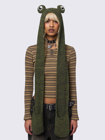 Knitted hooded scarf in green featuring a beanie-style hood with frog eyes and pockets at the scarf end.