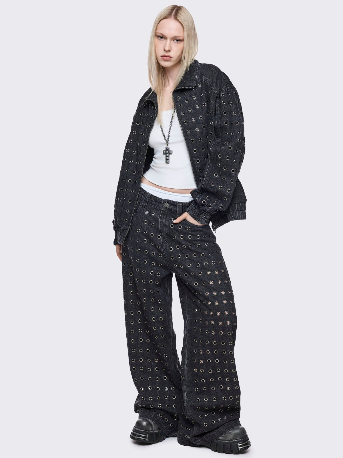 Black washed baggy jeans with all over silver eyelets. 