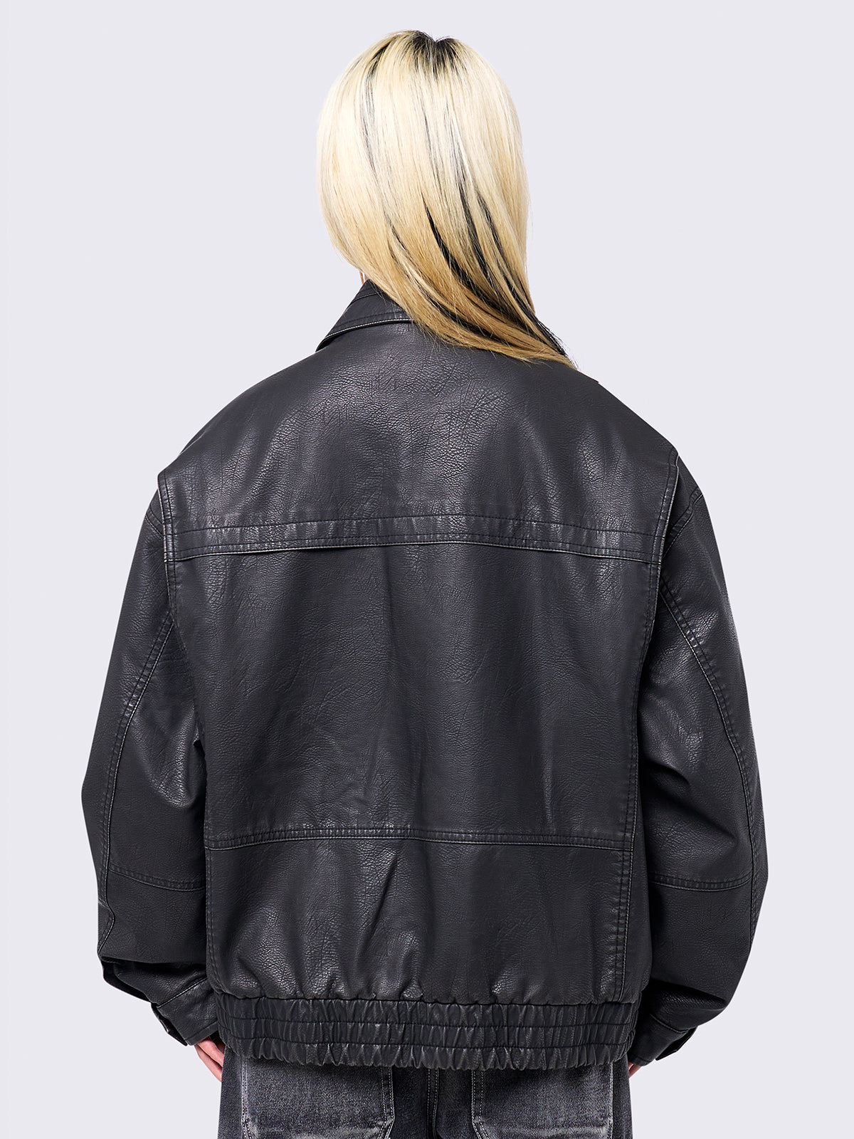 Black washed faux leather bomber jacket featuring a boxy oversize fit.