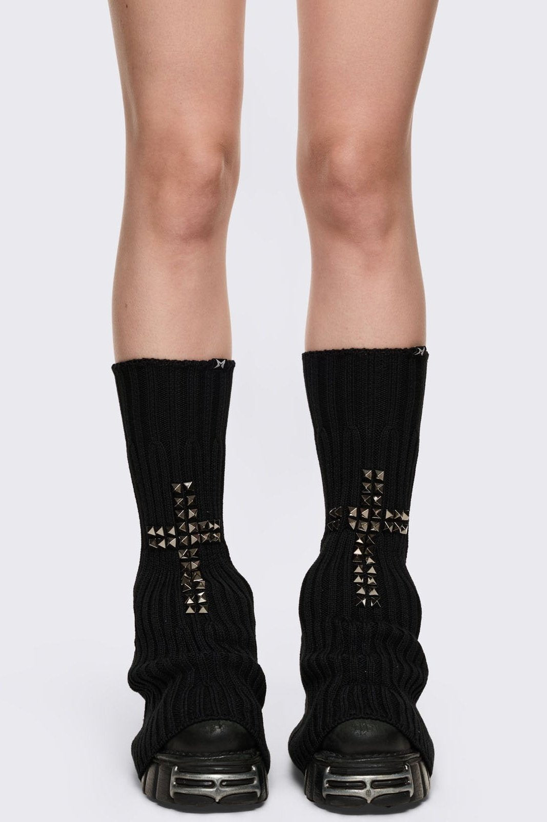 Black knitted flare leg warmers with silver studded cross design.