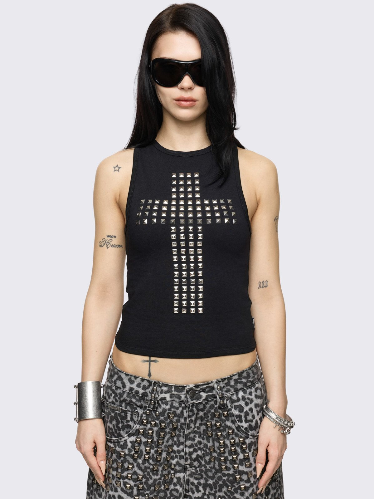 Black tank top with silver studded cross on front and cut-out slashed back.