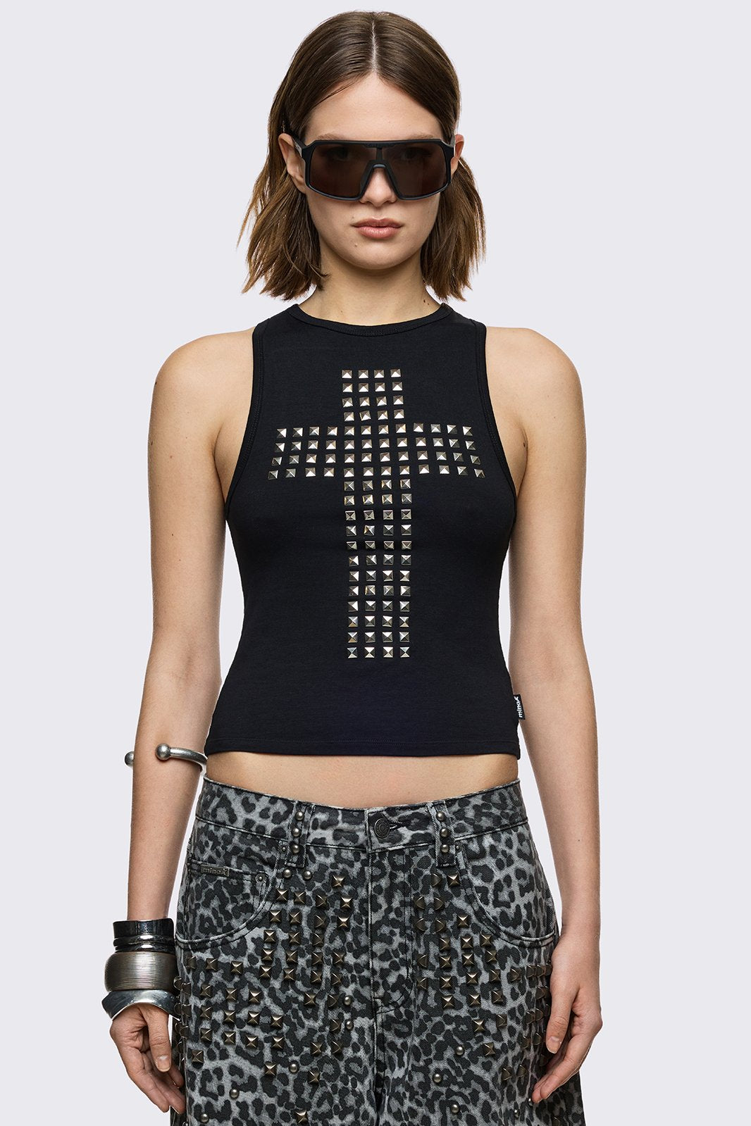 Black tank top with silver studded cross on front and cut-out slashed back.