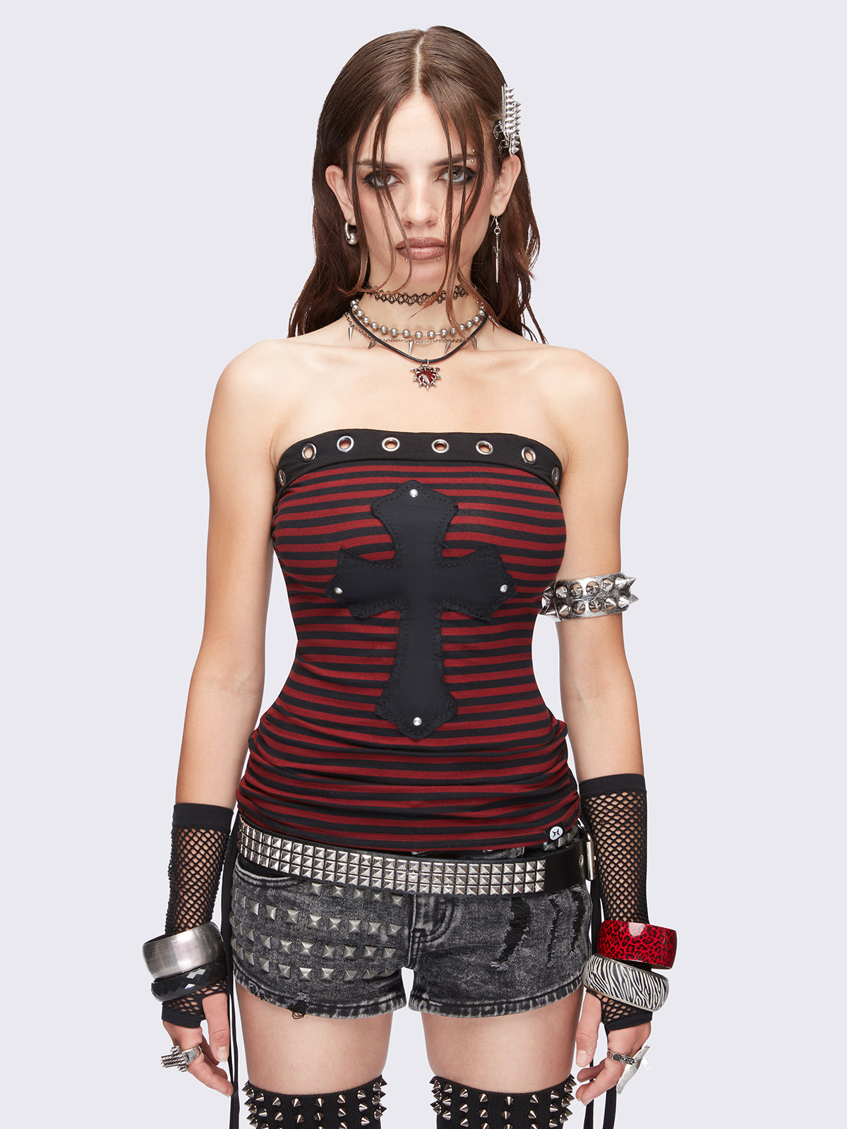Black and red striped tube top with cross patch featuring stud details, eyelet grommet trim and ruched tie side detail. Grunge goth aesthetic. 