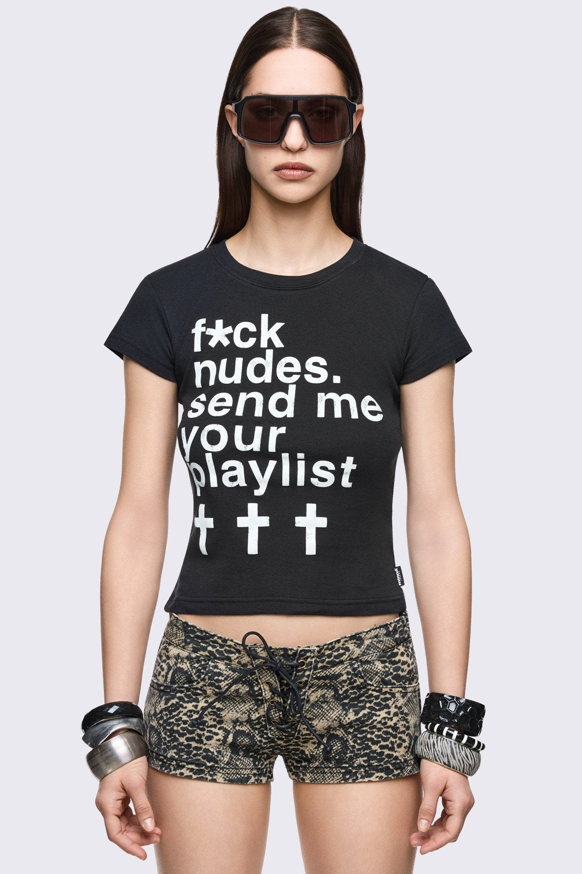 Black cotton baby tee with white slogan graphic print and grunge Y2K vibe.