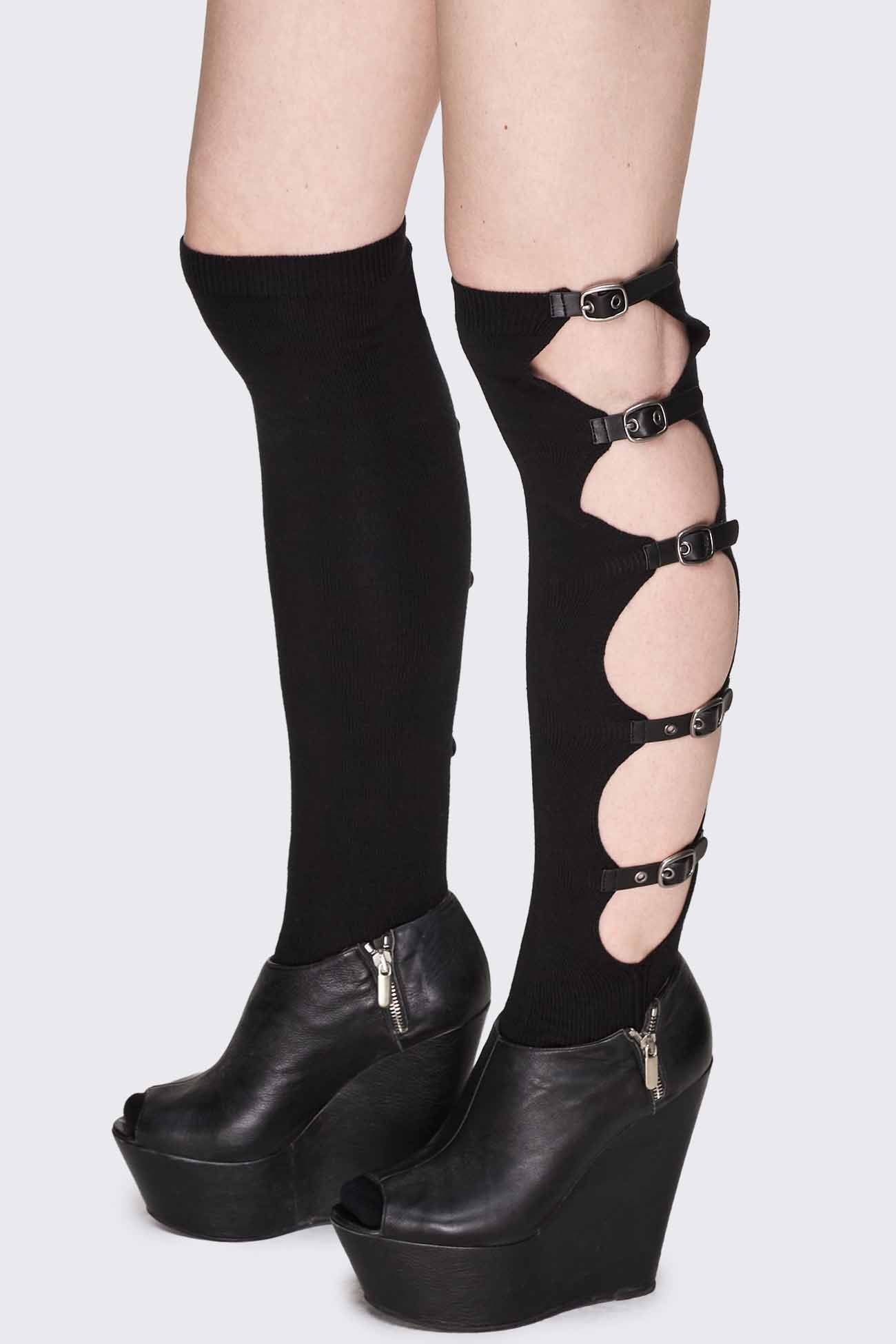 Black knee-high socks with side cut-outs, buckle straps, silver-tone hardware and ribbed cuffs.