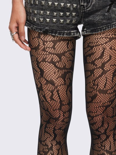 Black sigilism tribal fishnet tights.