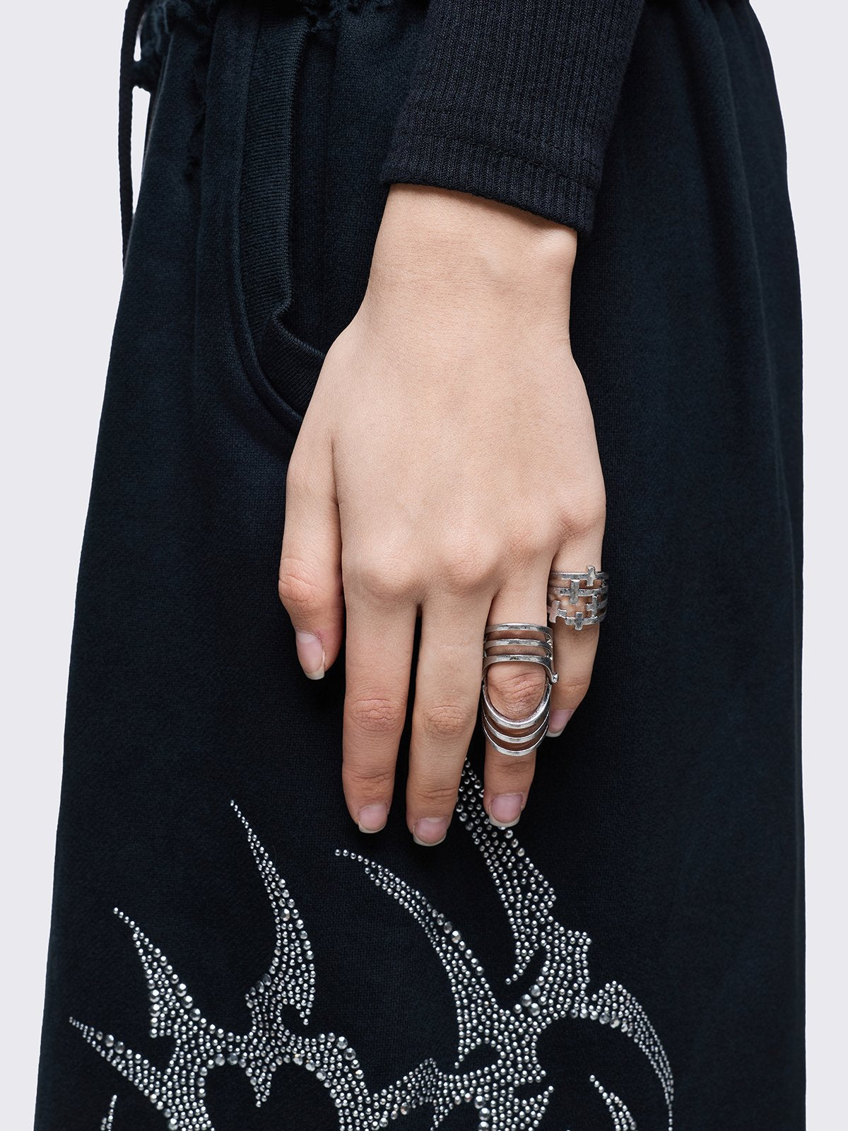 Silver set of 4 rings with cross designs.