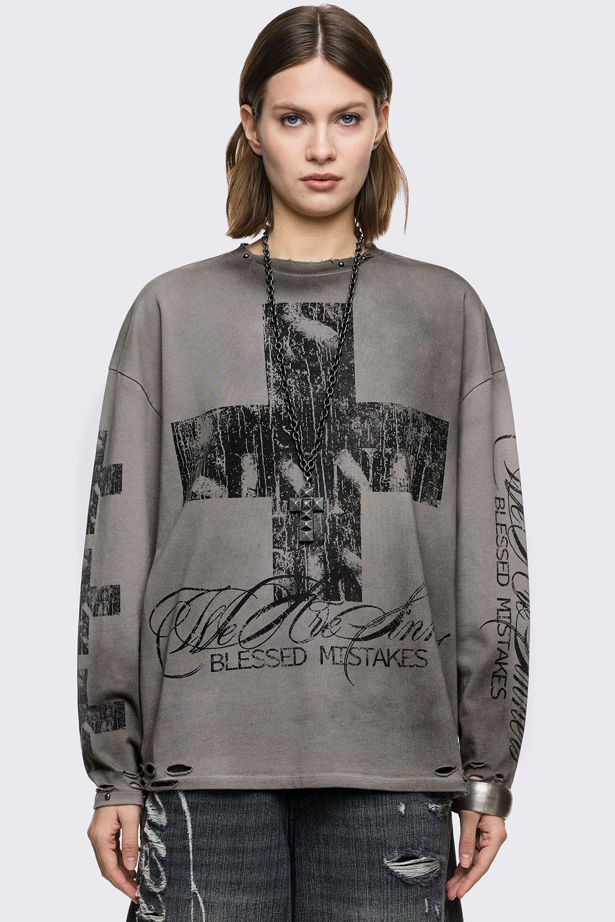 Grey cotton long sleeve T-shirt with cross graphic, studs and distressed hem in a grunge goth style.