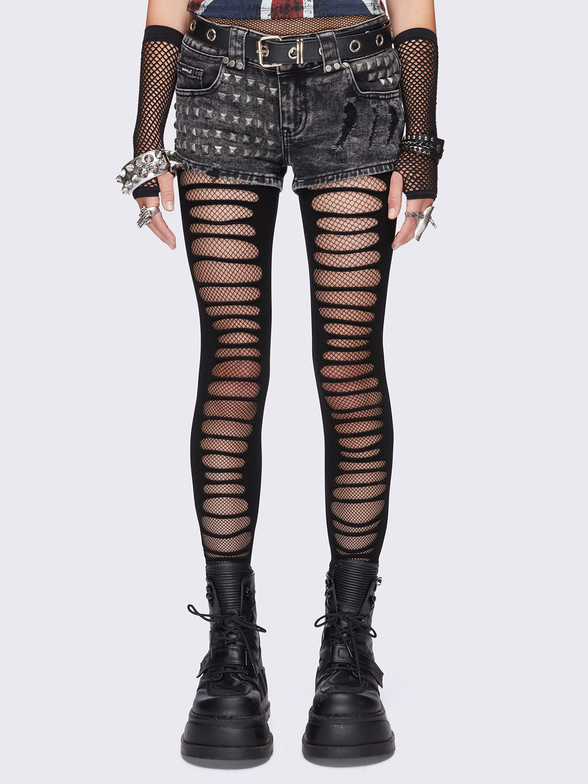 Black slashed cut-out tights with fishnet layer underneath.