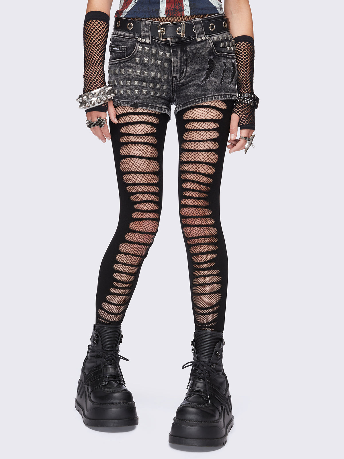 Black slashed cut-out tights with fishnet layer underneath.