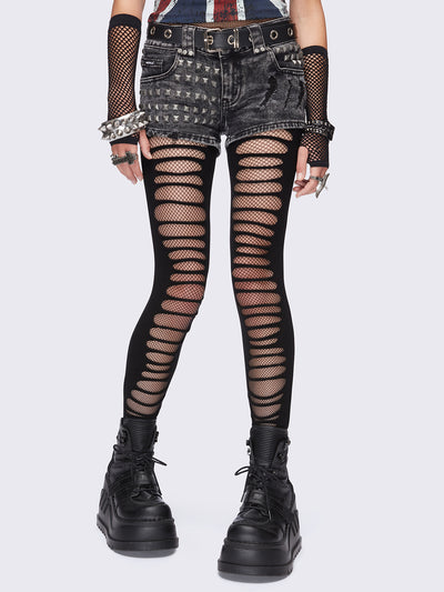 Black slashed cut-out tights with fishnet layer underneath.