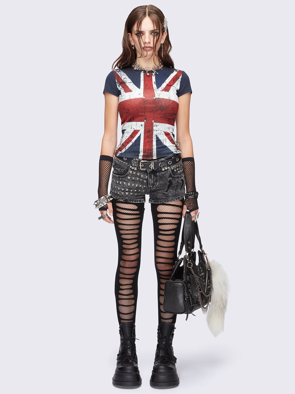 Black slashed cut-out tights with fishnet layer underneath.