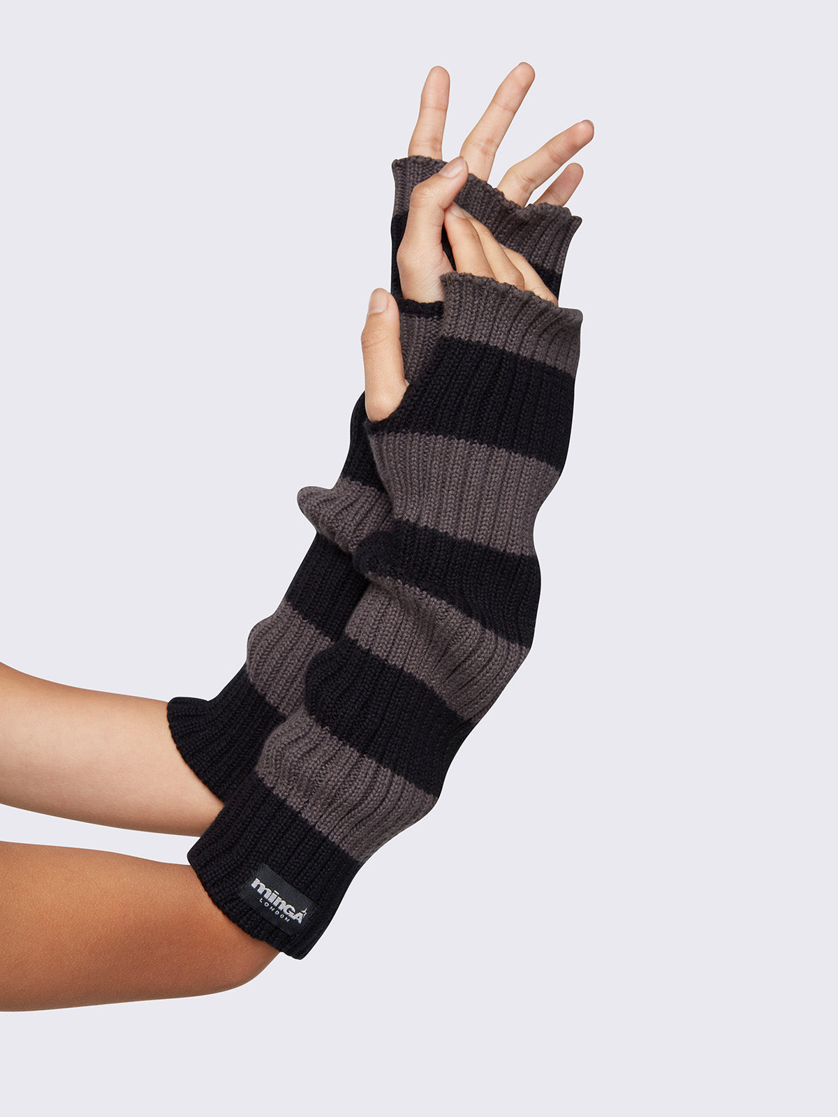 Chunky knitted arm warmers in grey and black stripes with thumbhole cuffs