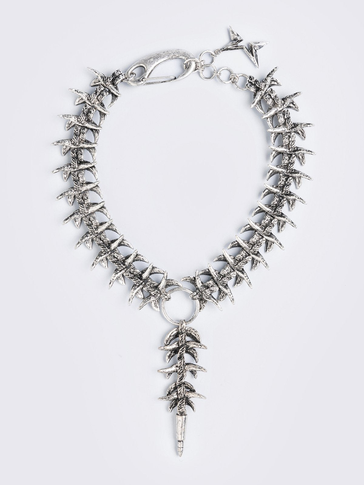 Silver chunky charm necklace featuring a spine design and spike pendant.