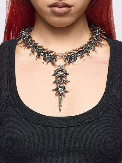 Silver chunky charm necklace featuring a spine design and spike pendant.
