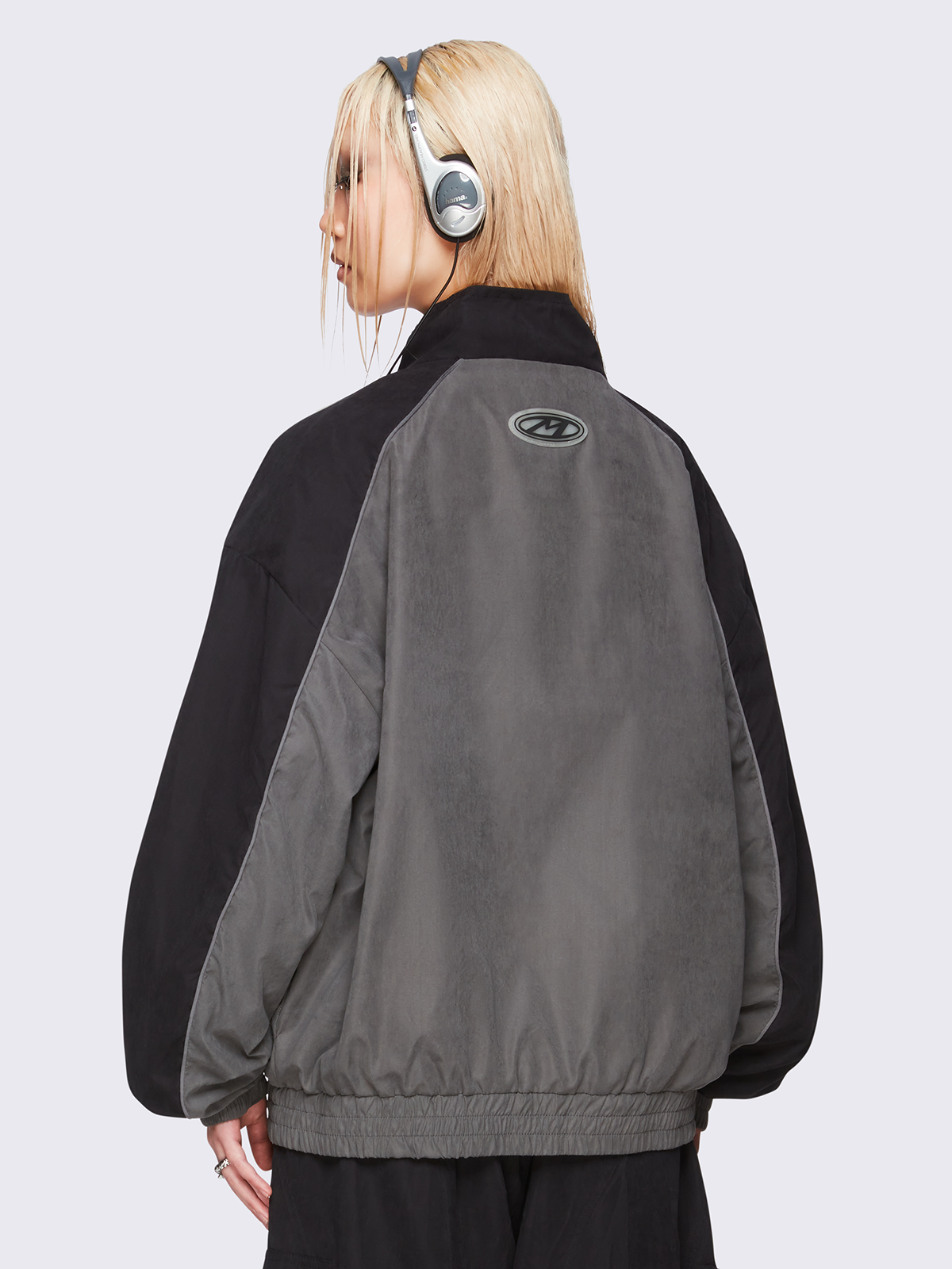 Black and grey color-block windbreaker with bold star graphic and oversized boxy fit— edgy, utility-inspired streetwear style.