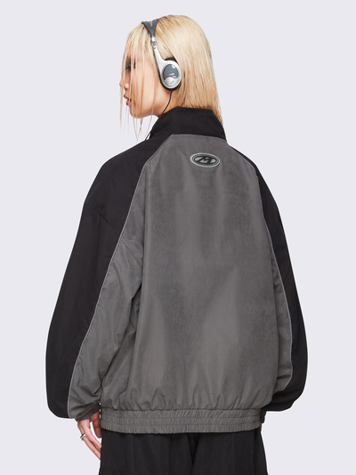 Black and grey color-block windbreaker with bold star graphic and oversized boxy fit— edgy, utility-inspired streetwear style.