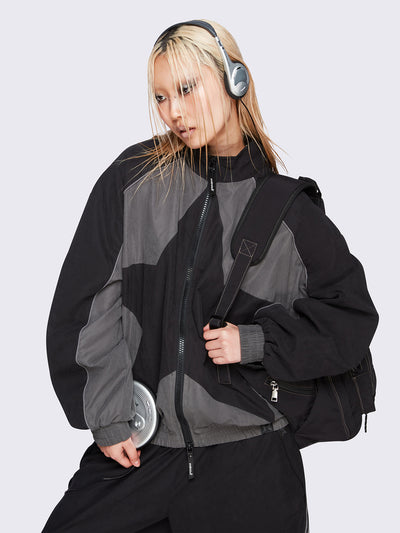 Black and grey color-block windbreaker with bold star graphic and oversized boxy fit— edgy, utility-inspired streetwear style.