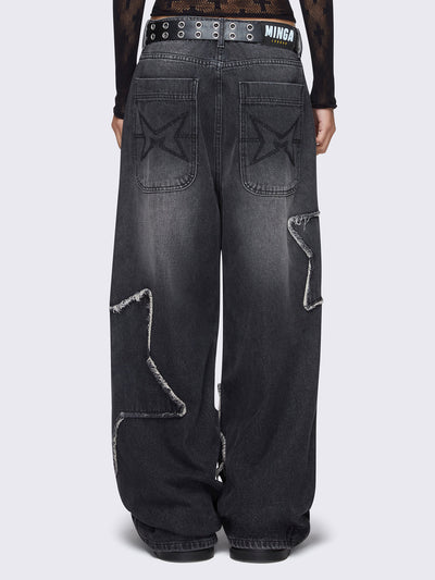 Baggy jeans in washed black with frayed star patches and wide leg fit. 