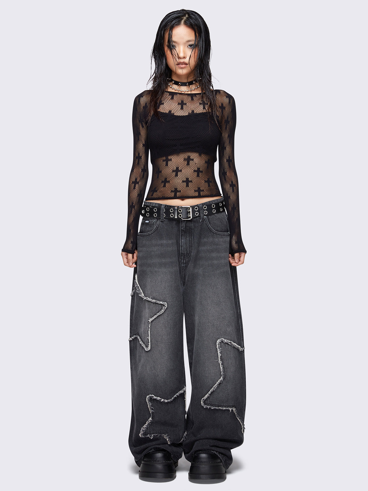 Baggy jeans in washed black with frayed star patches and wide leg fit. 