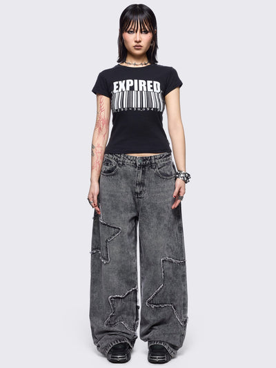 Grey washed baggy jeans with frayed star patches.