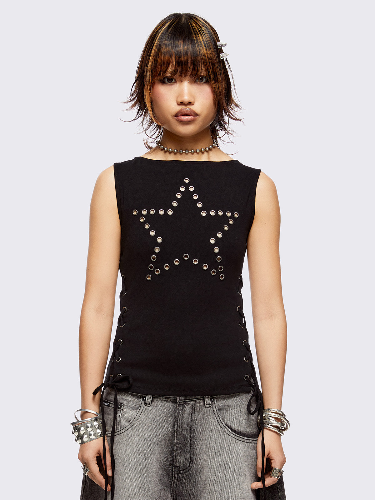 Black tank top with star-shaped eyelet detail and adjustable lace-up sides.