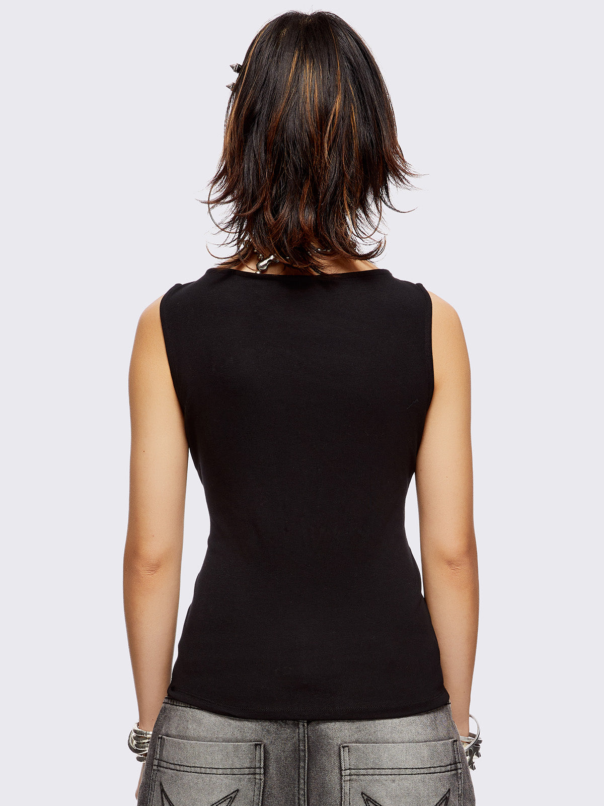 Black tank top with star-shaped eyelet detail and adjustable lace-up sides.