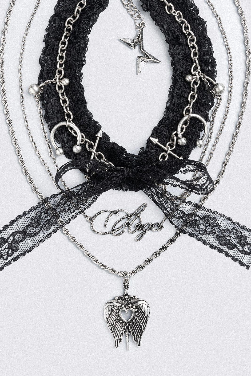 Set of 3 necklaces, black lace bow choker with piercings and chain  and "Angel" tag and winged heart pendants.