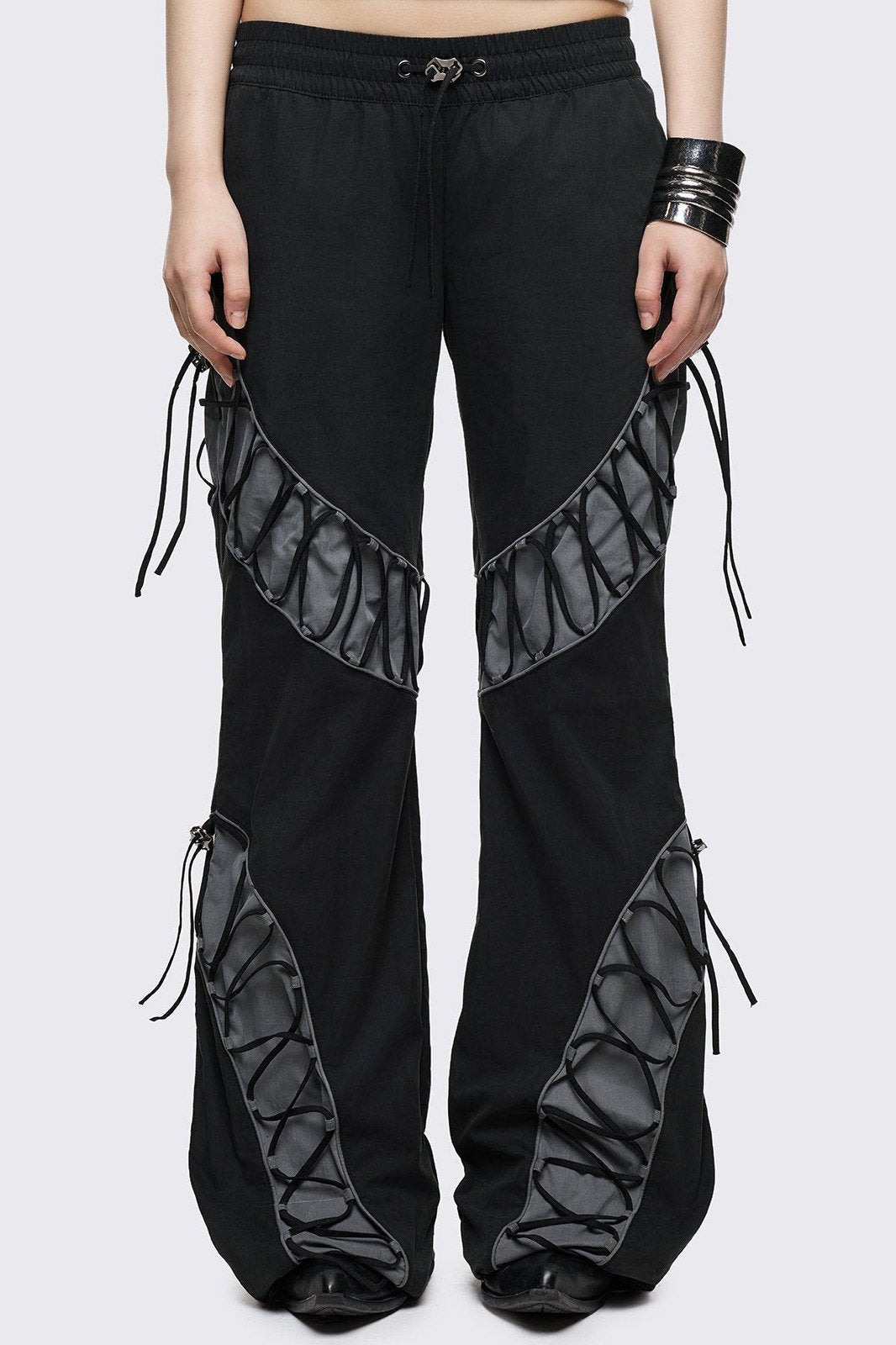 Black parachute baggy flared pants with grey panels with lace up. 