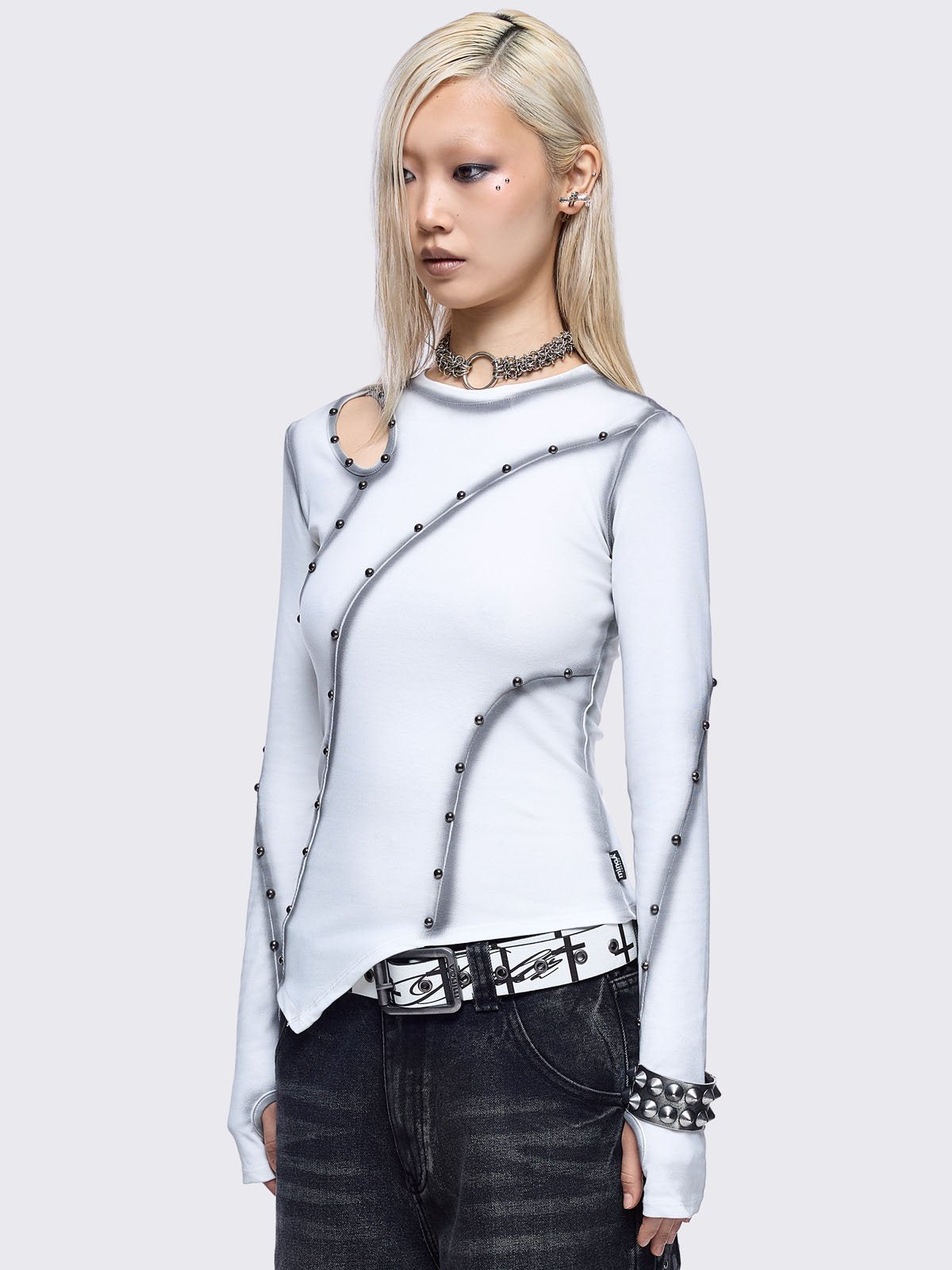 Off-white asymmetric top featuring cut out, contrast seam and stud details and thumbhole cuffs.