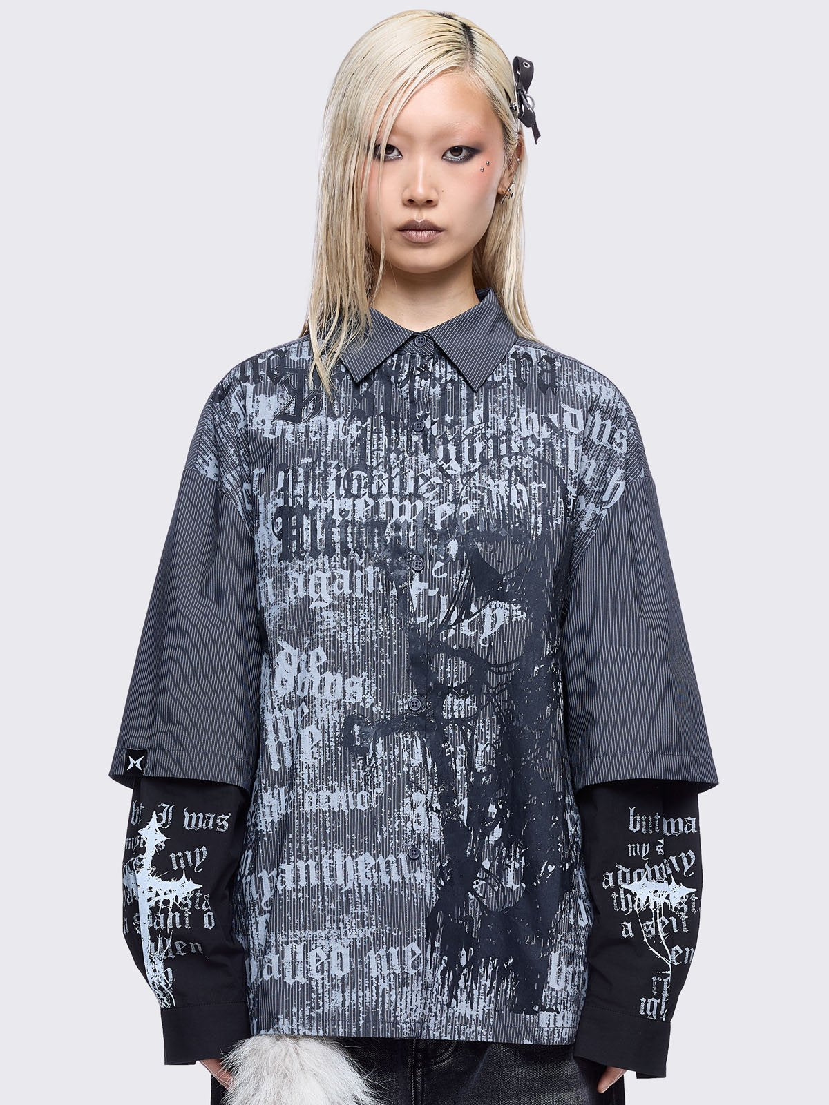 Two-piece gothic shirt ensemble featuring a pinstriped outer layer with a distressed text print, over black long sleeves detailed with white gothic text and imagery.