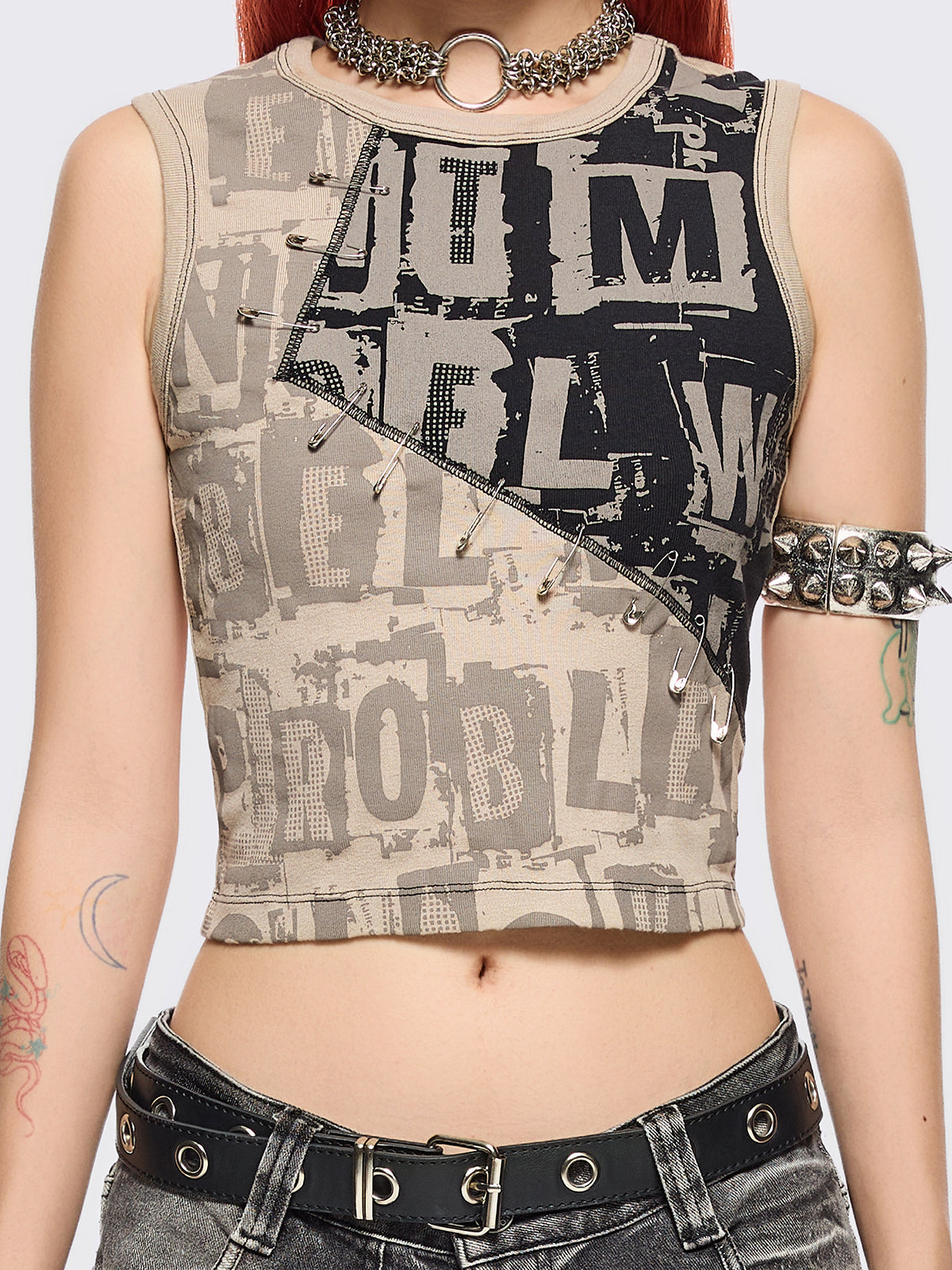 Beige and black patchwork tank top with grunge graphic front print in contrast featuring safety pin details and black contrast stitching.
