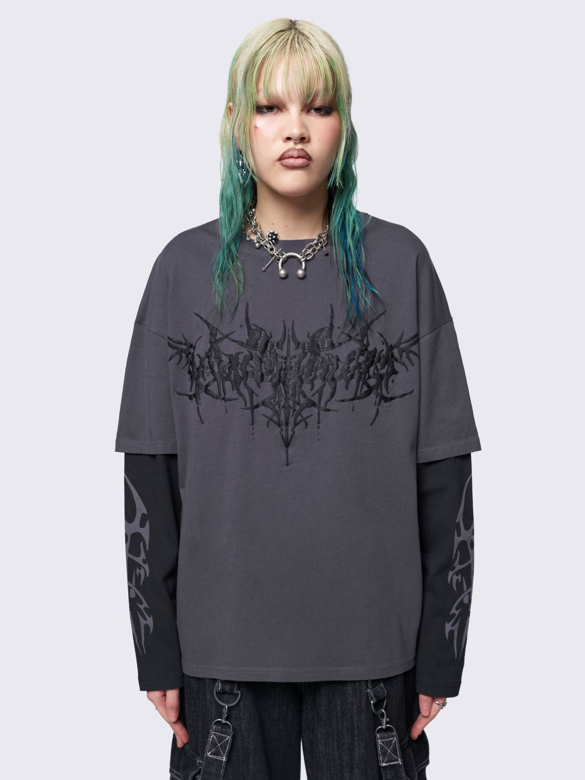 Layered long sleeve t-shirt in grey with contrast sleeves in black and sigilism graphic front and sleeves.