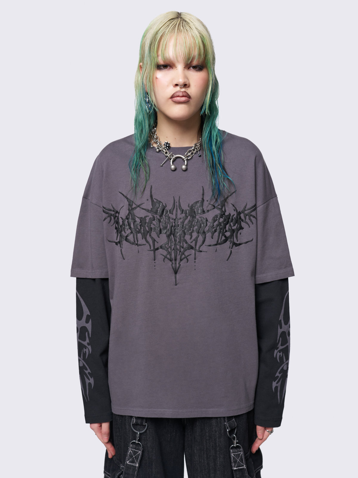 Layered long sleeve t-shirt in grey with contrast sleeves in black and sigilism graphic front and sleeves.