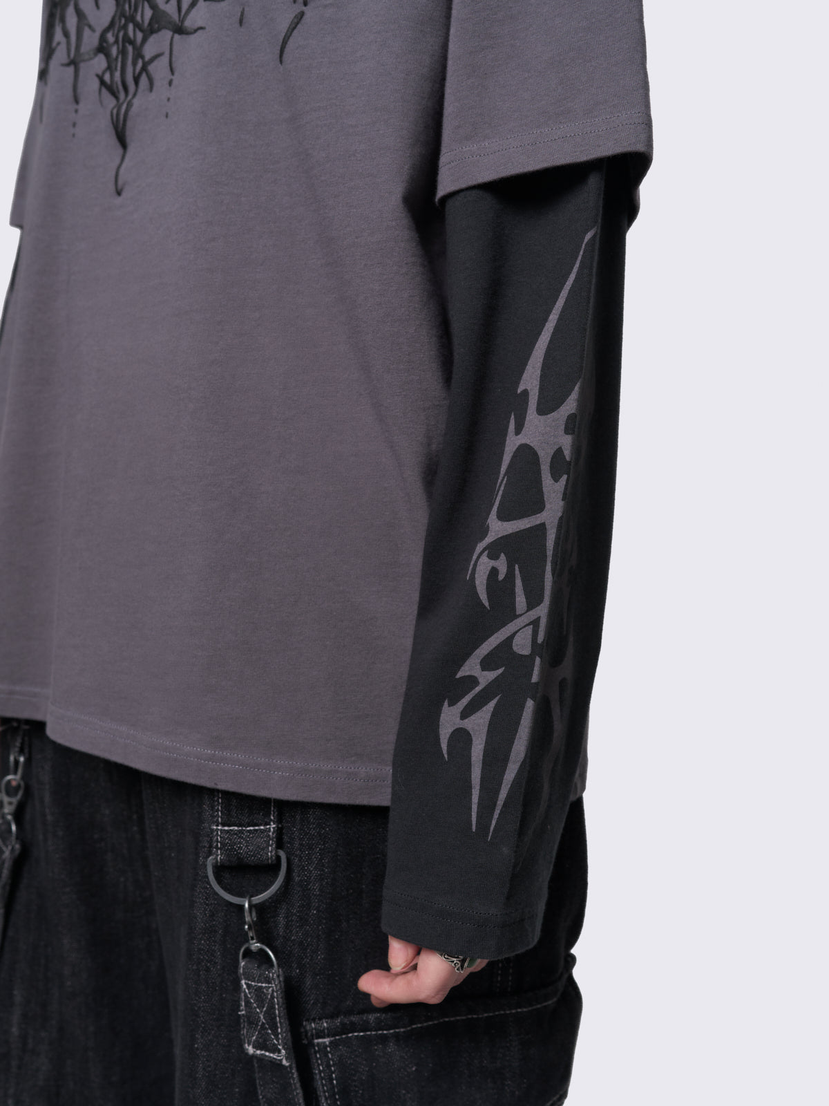 Layered long sleeve t-shirt in grey with contrast sleeves in black and sigilism graphic front and sleeves.