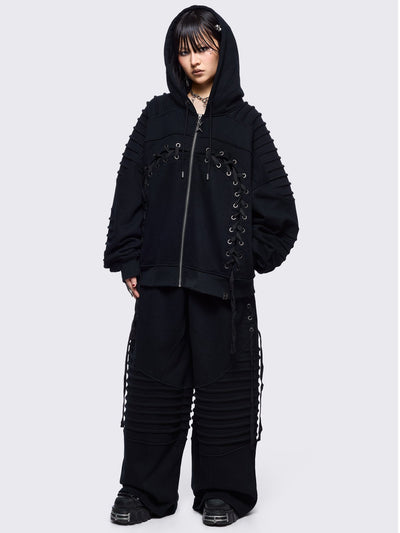 Black zip up hoodie jacket featuring a moto pintuck panels and front lace corset details. 
