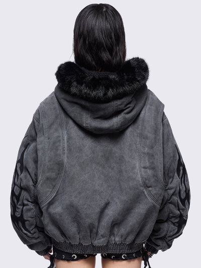 Grey washed denim bomber jacket featuring black sigilism patches and black faux fur hood.