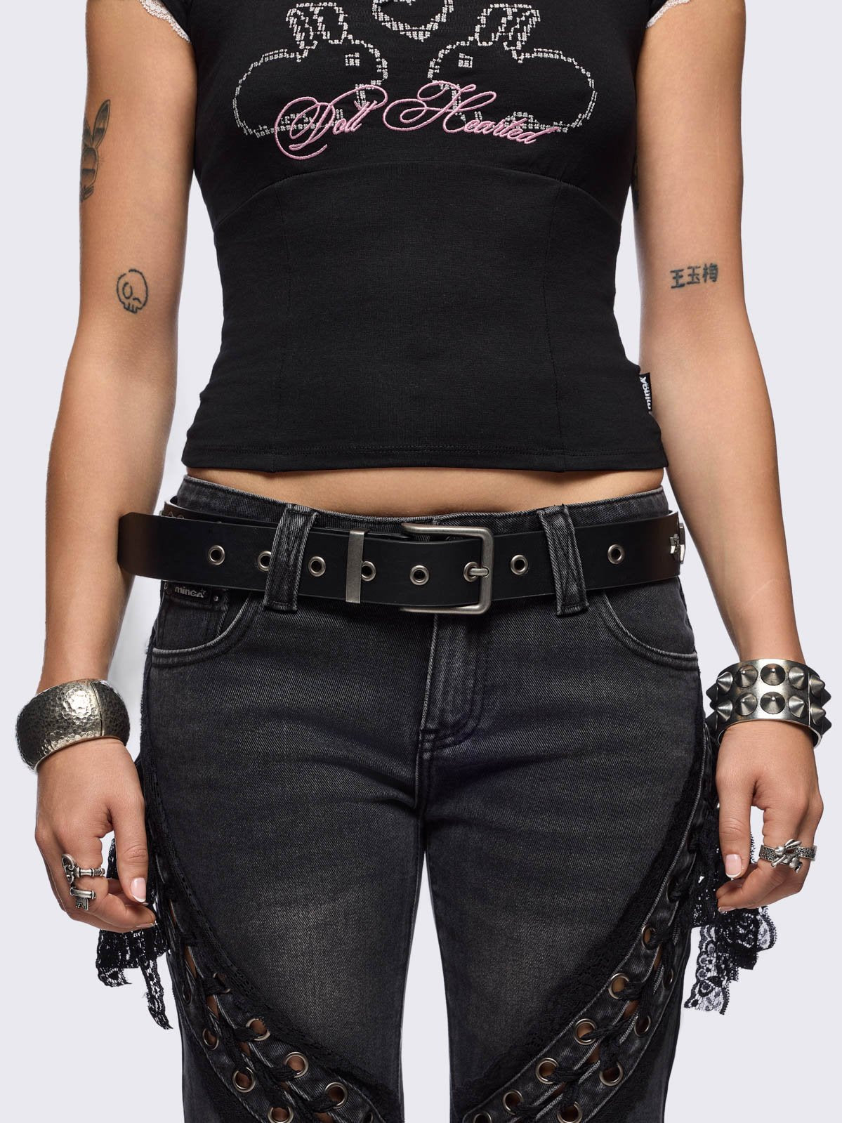 Black vegan leather belt featuring silver hardware and star details.
