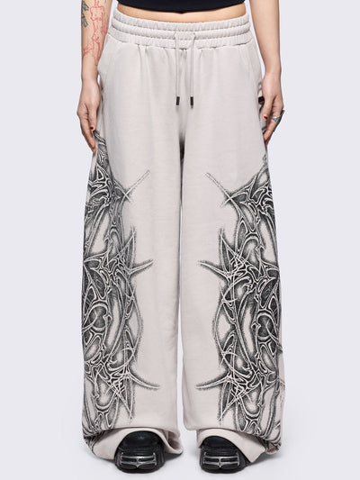 Grey wide leg sweatpants featuring a black sigilism graphic side print.