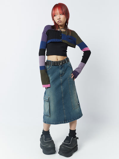 A 00s-inspired denim maxi cargo skirt named Kady by Minga London. This skirt combines the style of a cargo design with the length of a maxi skirt, creating a unique and fashionable look.