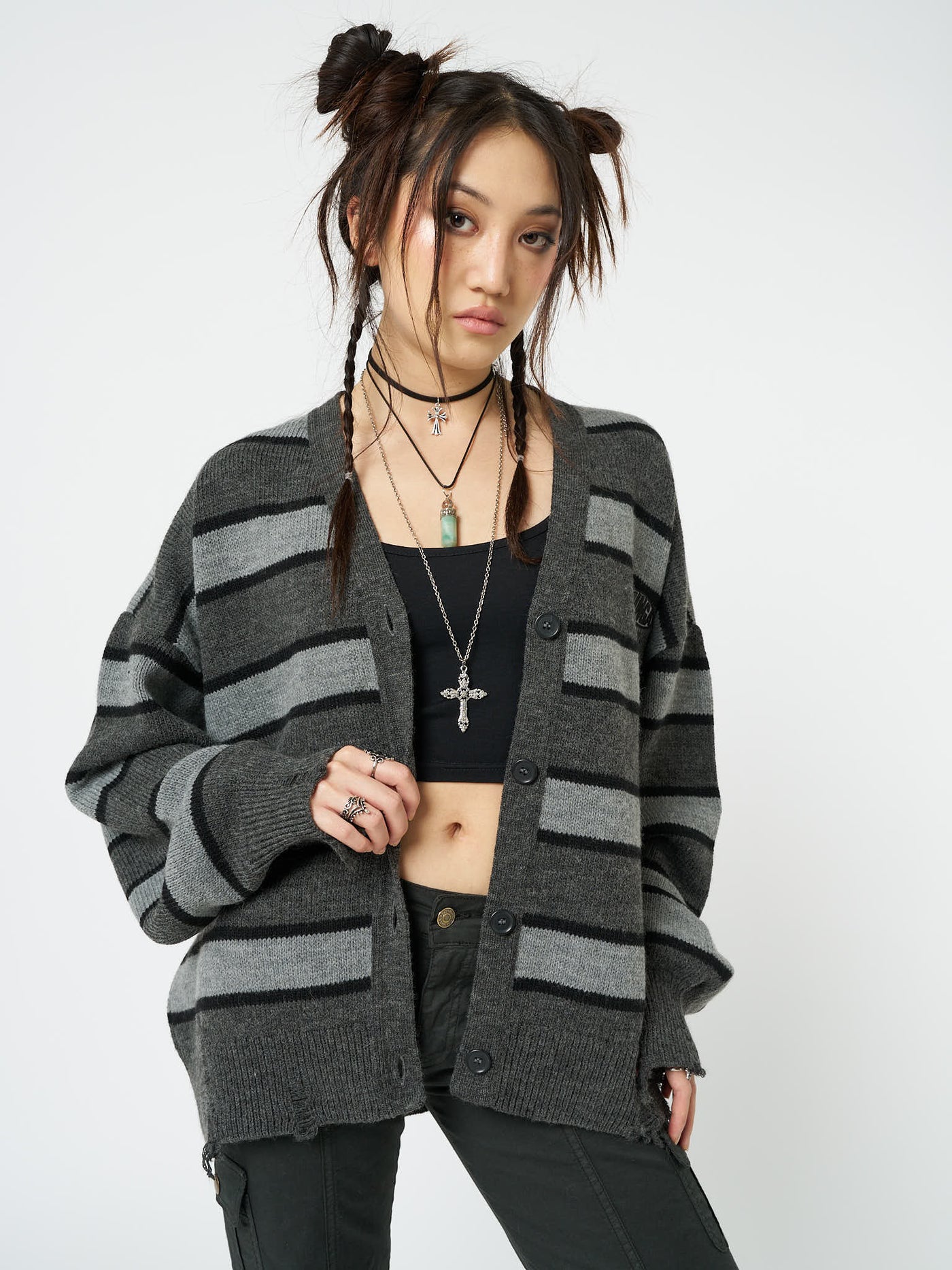 Knit cardigan named Neesa by Minga London, featuring grey and black stripes for a fashionable and relaxed look, perfect for layering and adding texture to your outfit.